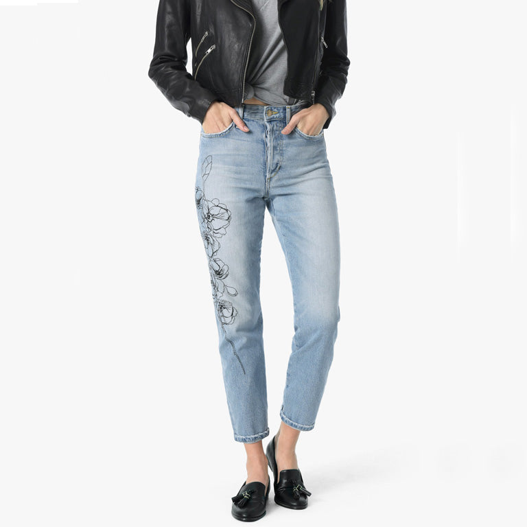 A woman wearing a leather jacket and Joe's Jeans Smith High Rise Straight - Jazzie jeans.