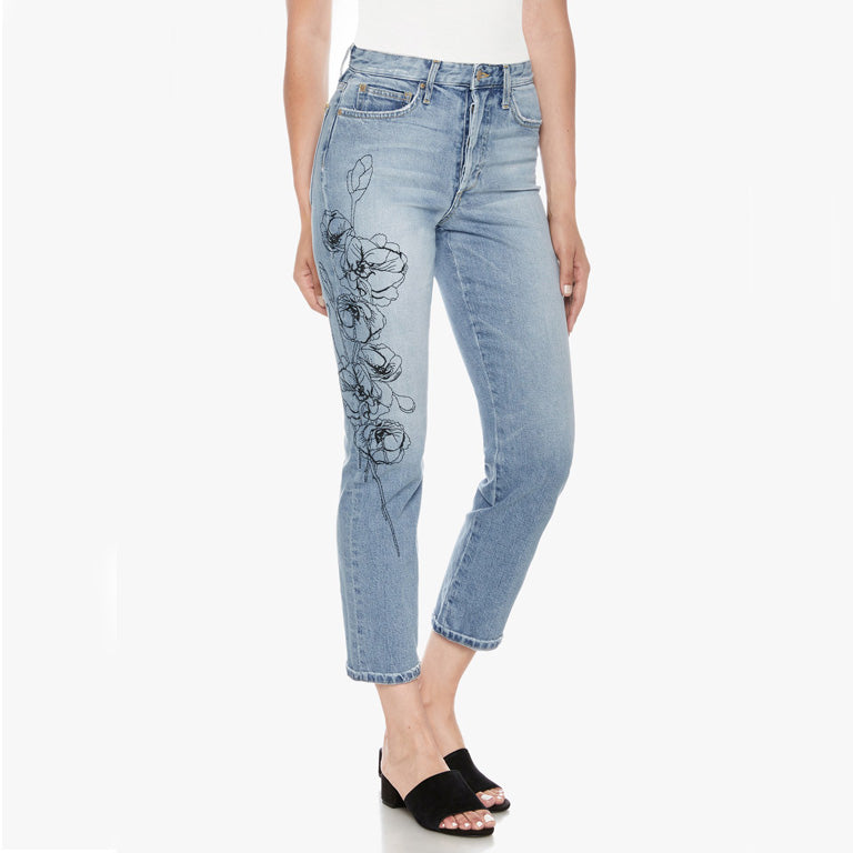 A woman wearing a pair of Joe's Jeans The Smith High Rise Straight - Jazzie embroidered denim jeans with a floral pattern.