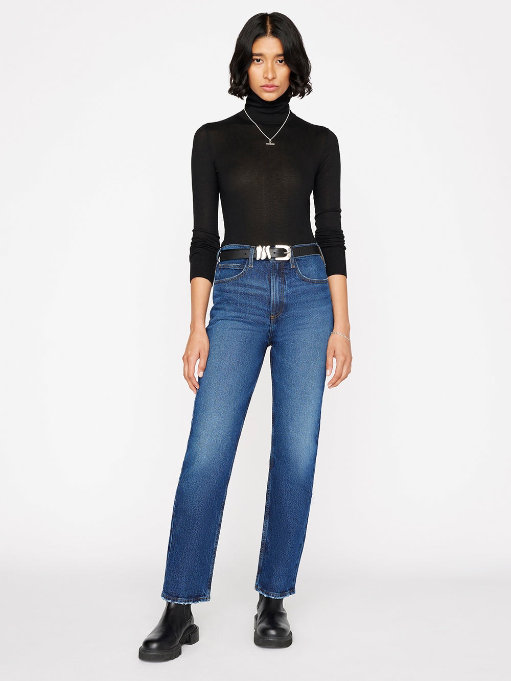 The model is wearing a Frame Le High 'N' Tight Straight - Hallam turtle neck and jeans.