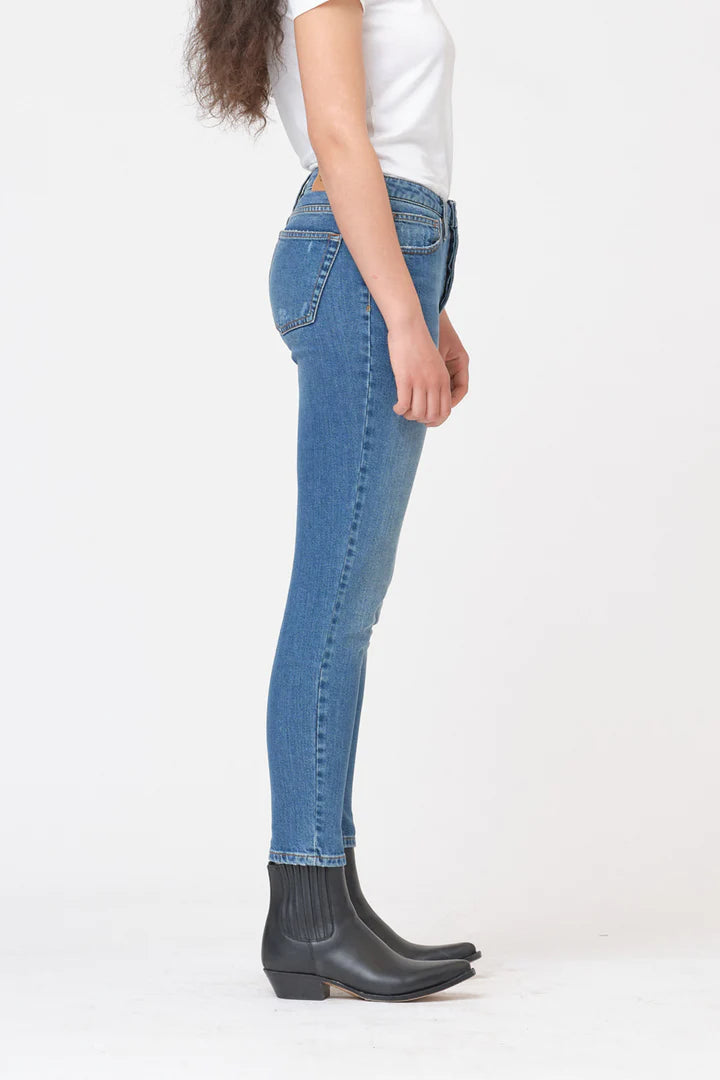 The back view of a woman wearing a pair of Hepburn Slim Jeans in black denim fabric by Tomorrow Denim.