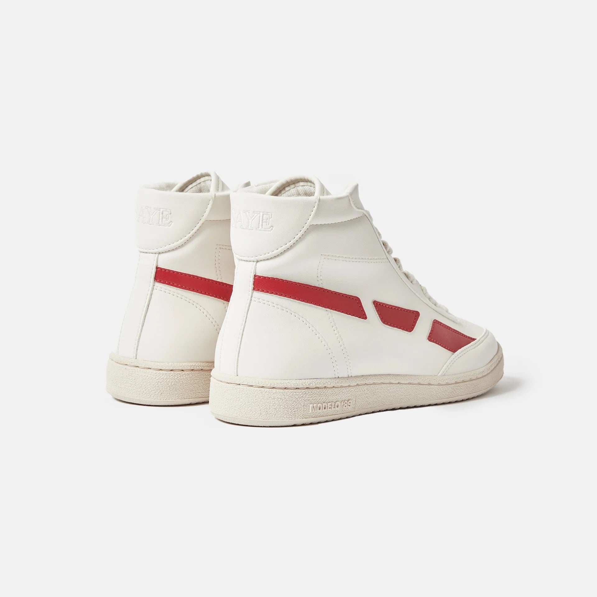 A pair of Modelo '89 Hi Sneakers by SAYE on a white background with vegan leather.