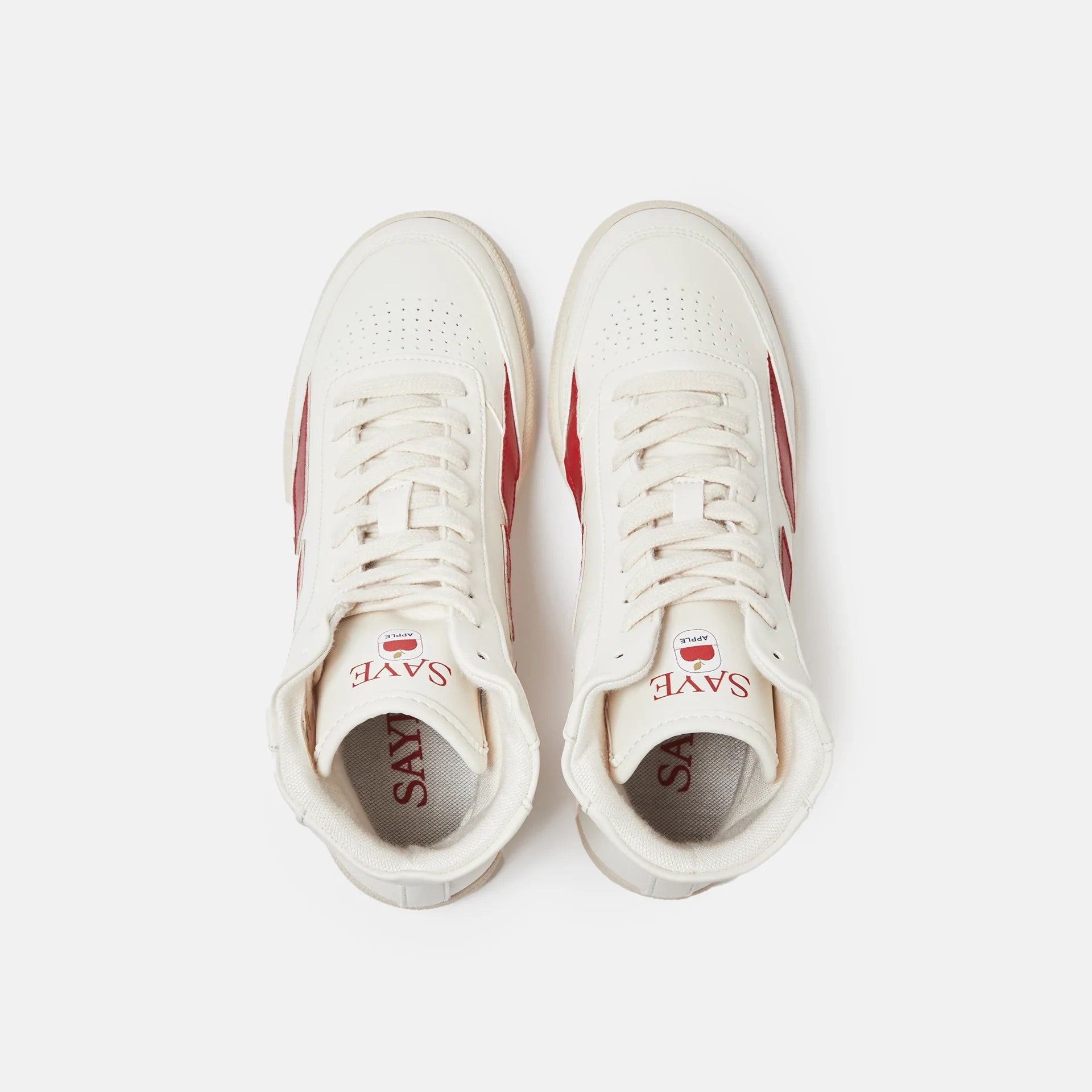 A pair of Modelo '89 Hi Sneakers by SAYE on a white surface, made with vegan leather and featuring a bamboo lining.