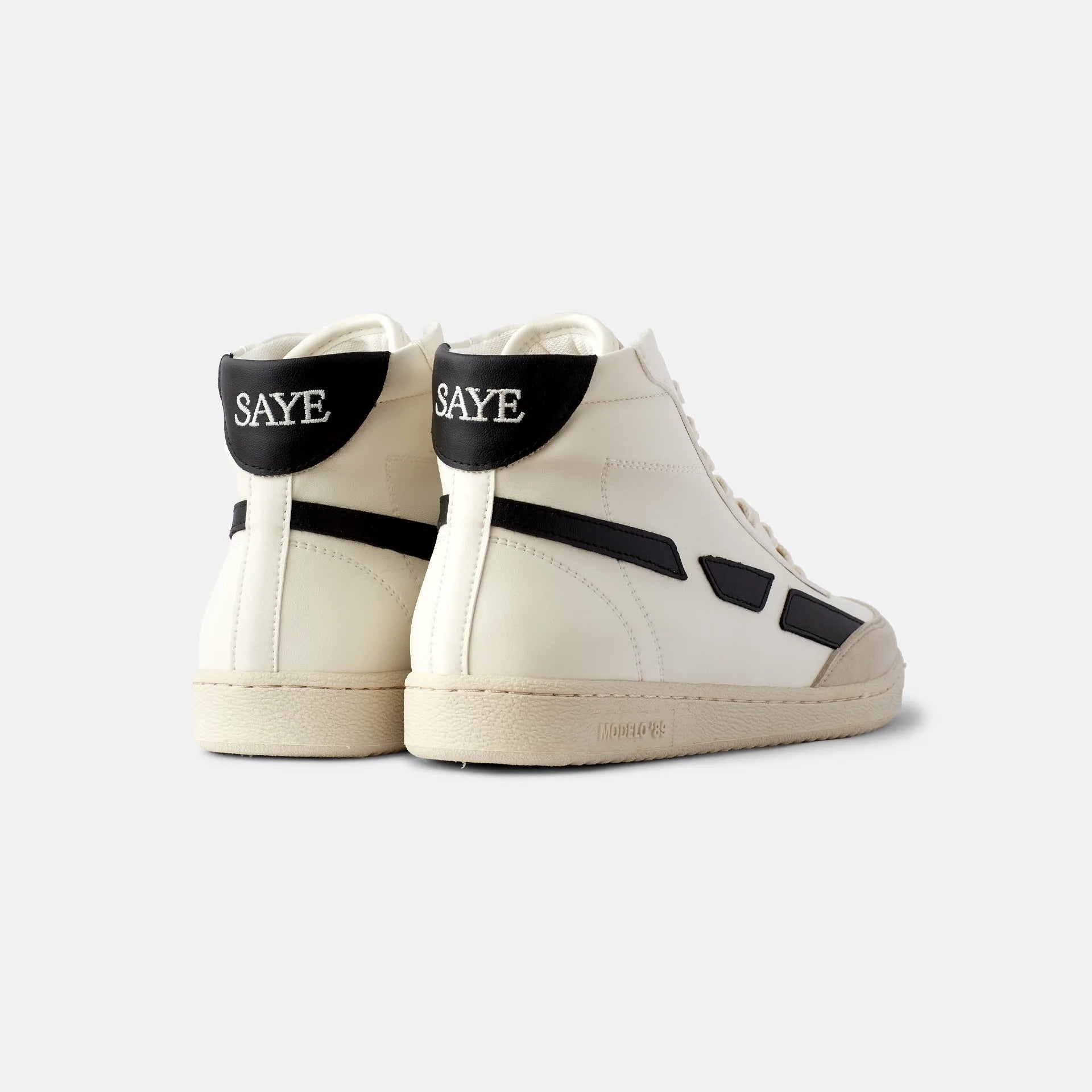 A pair of SAYE Modelo '89 Hi Sneakers - Black with the word 'save' on them, made from corn leather.