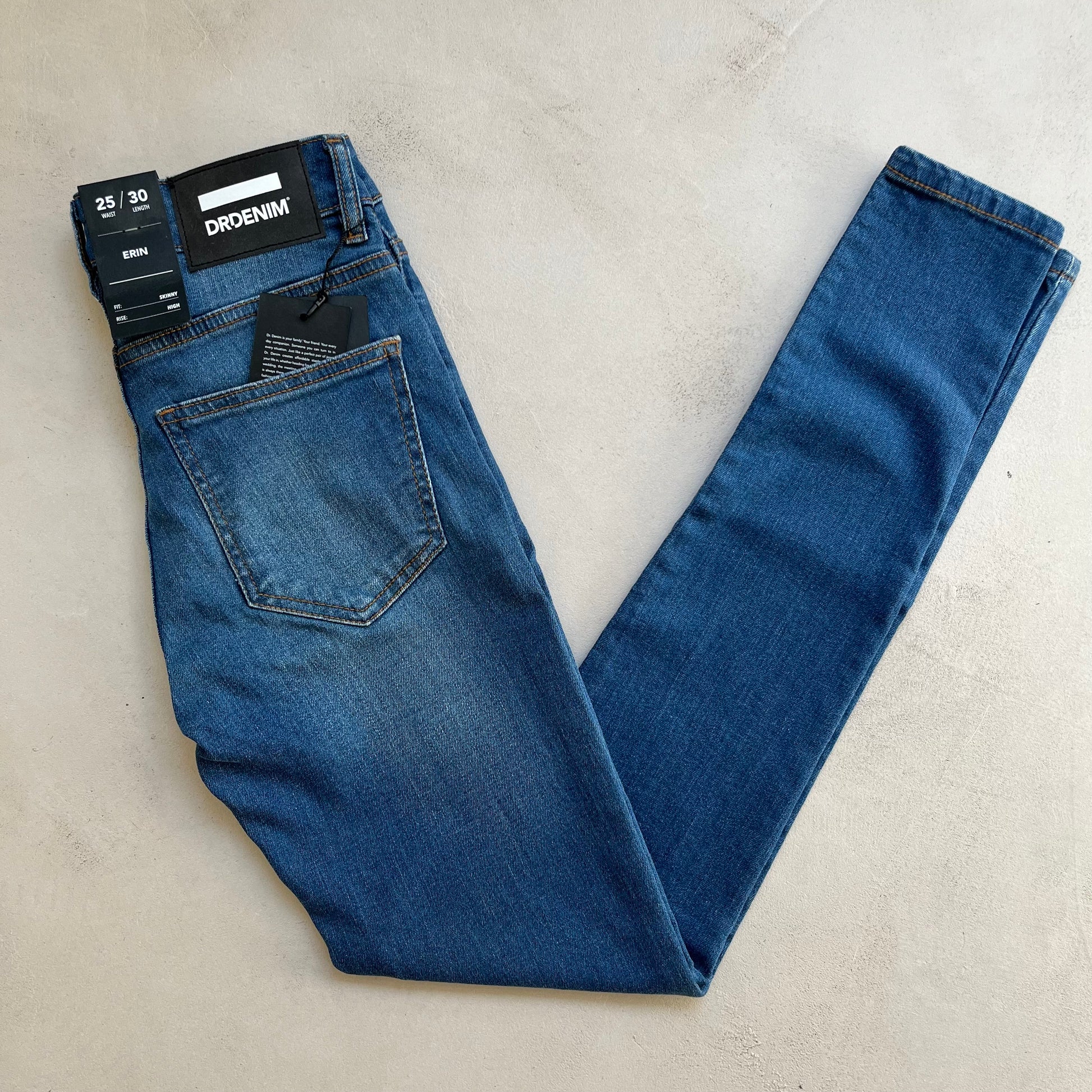 A pair of high-rise Erin - Washed Blue jeans with a Dr Denim tag on them.