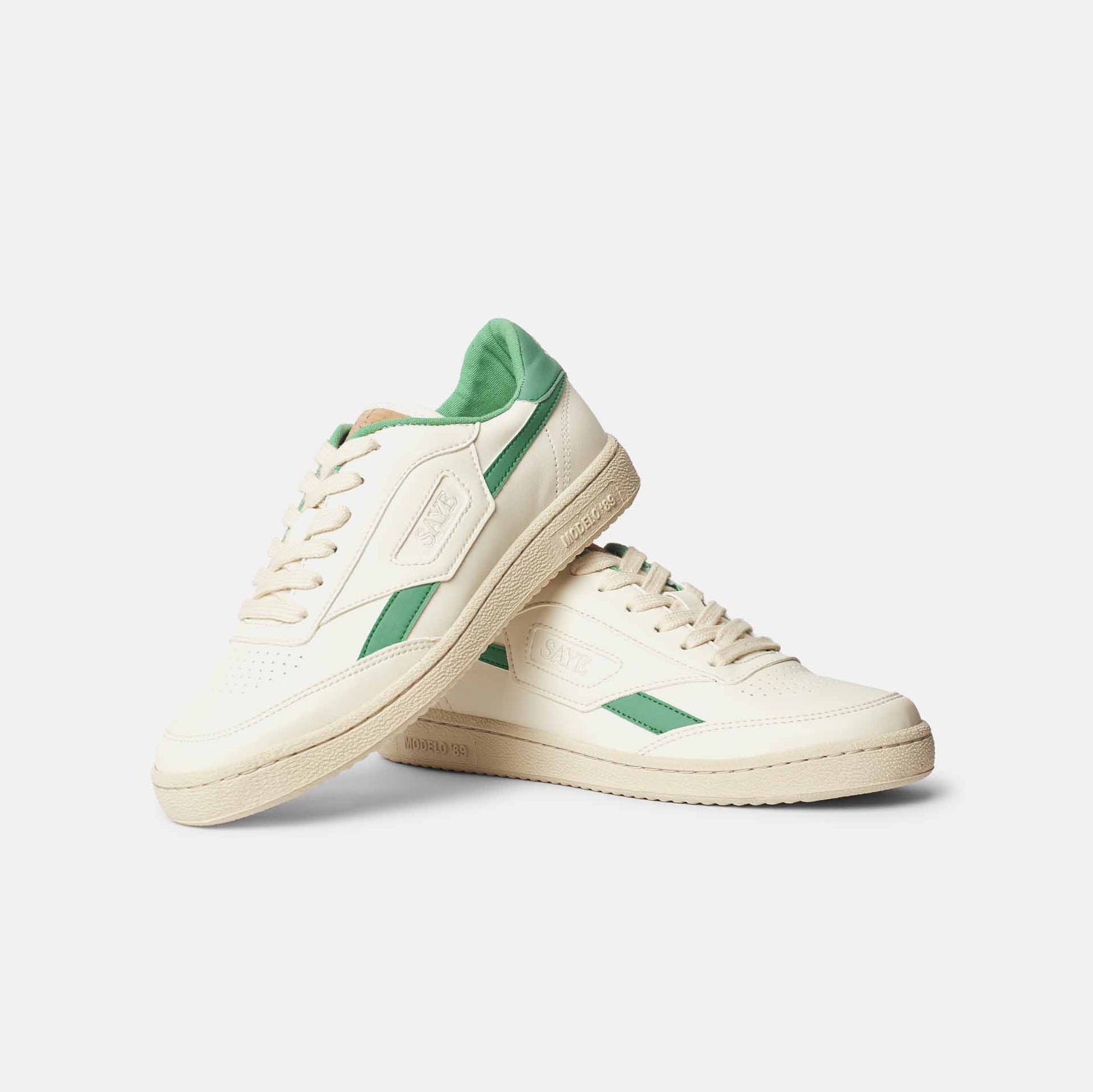 A pair of SAYE Modelo '89 Sneakers - Green on a white surface made with recycled and organic materials.