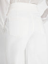Woman wears triple wide leg by frame in bright white