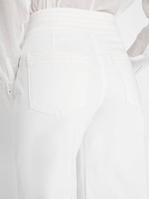 Woman wears triple wide leg by frame in bright white
