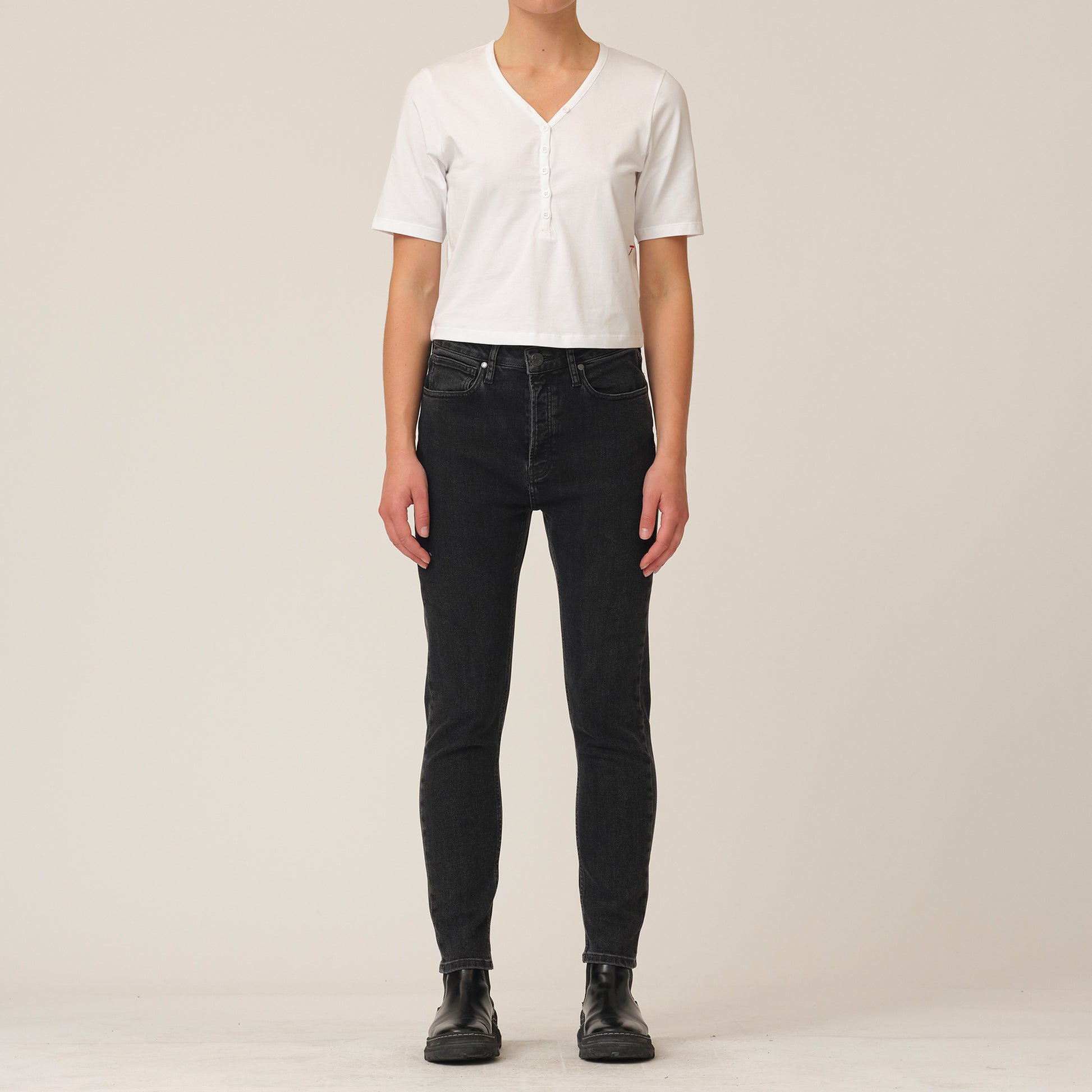 The model is wearing Hepburn Slim Jeans - Original Black by Tomorrow Denim and a white organic cotton t-shirt.