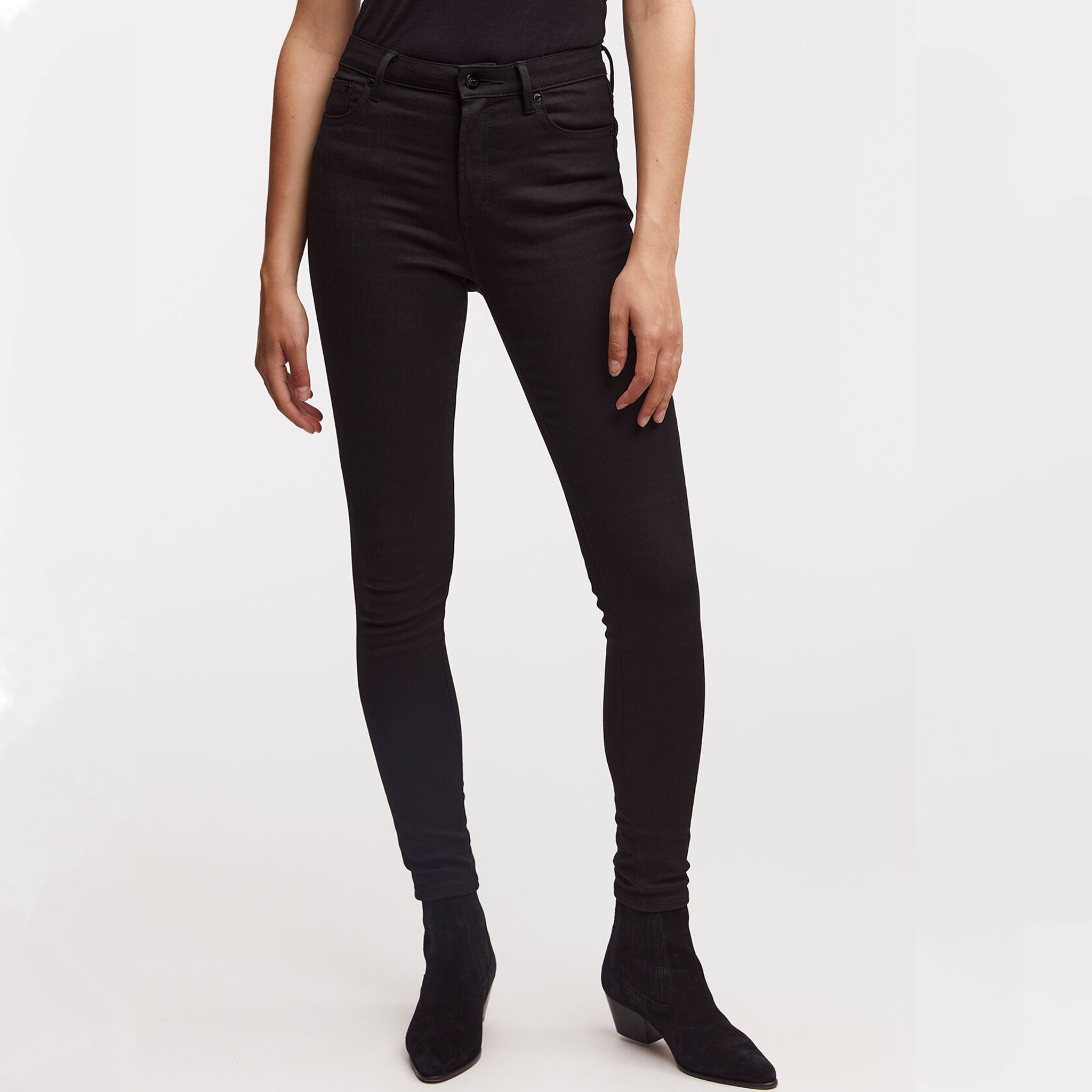 A woman wearing Denham's NEEDLE Skinny - True Black denim jeans.