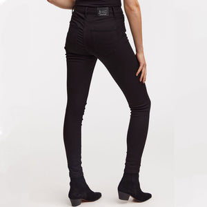 Woman wears black skinny needle jeans by Denham