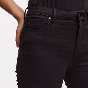 Woman wears black skinny needle jeans by Denham