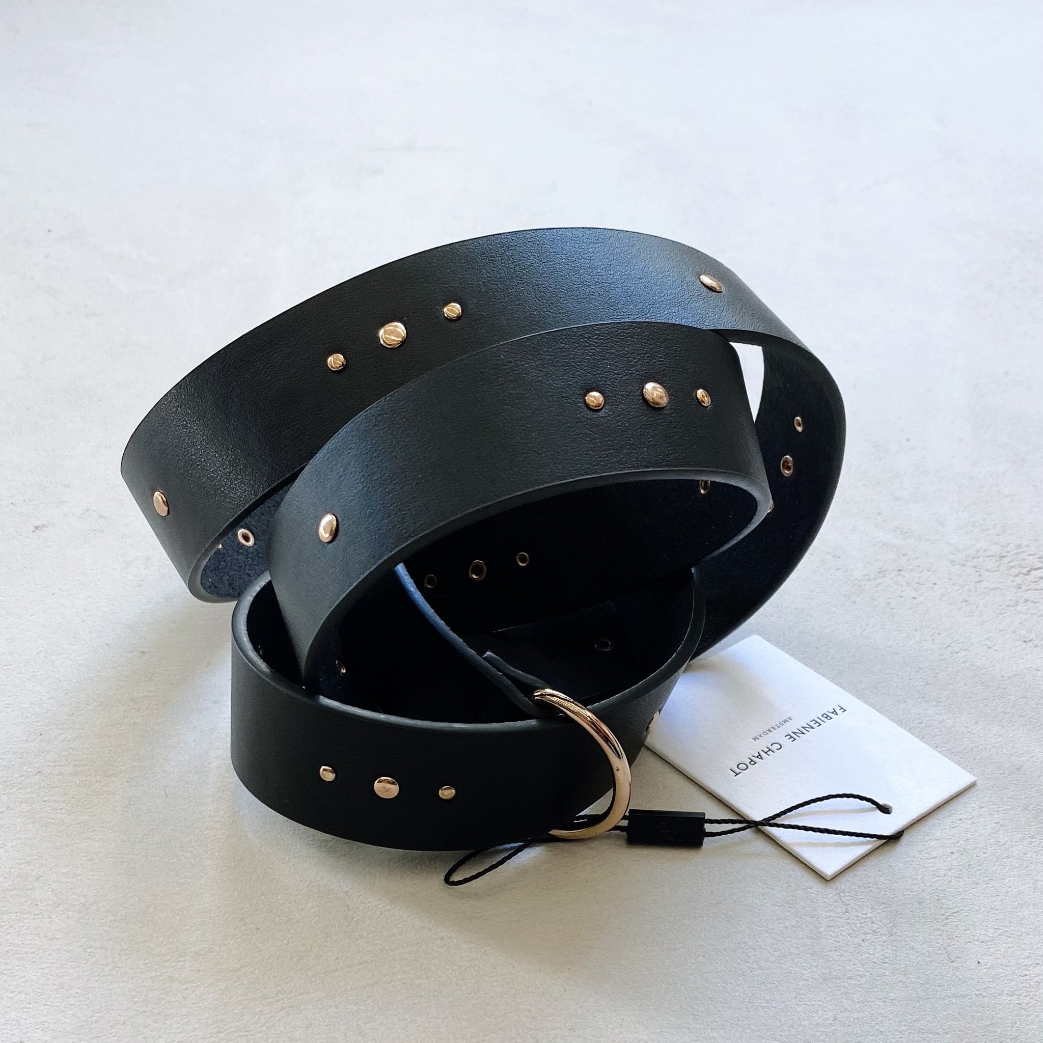 A Fabienne Chapot studded belt - black, adorned with gold studs.