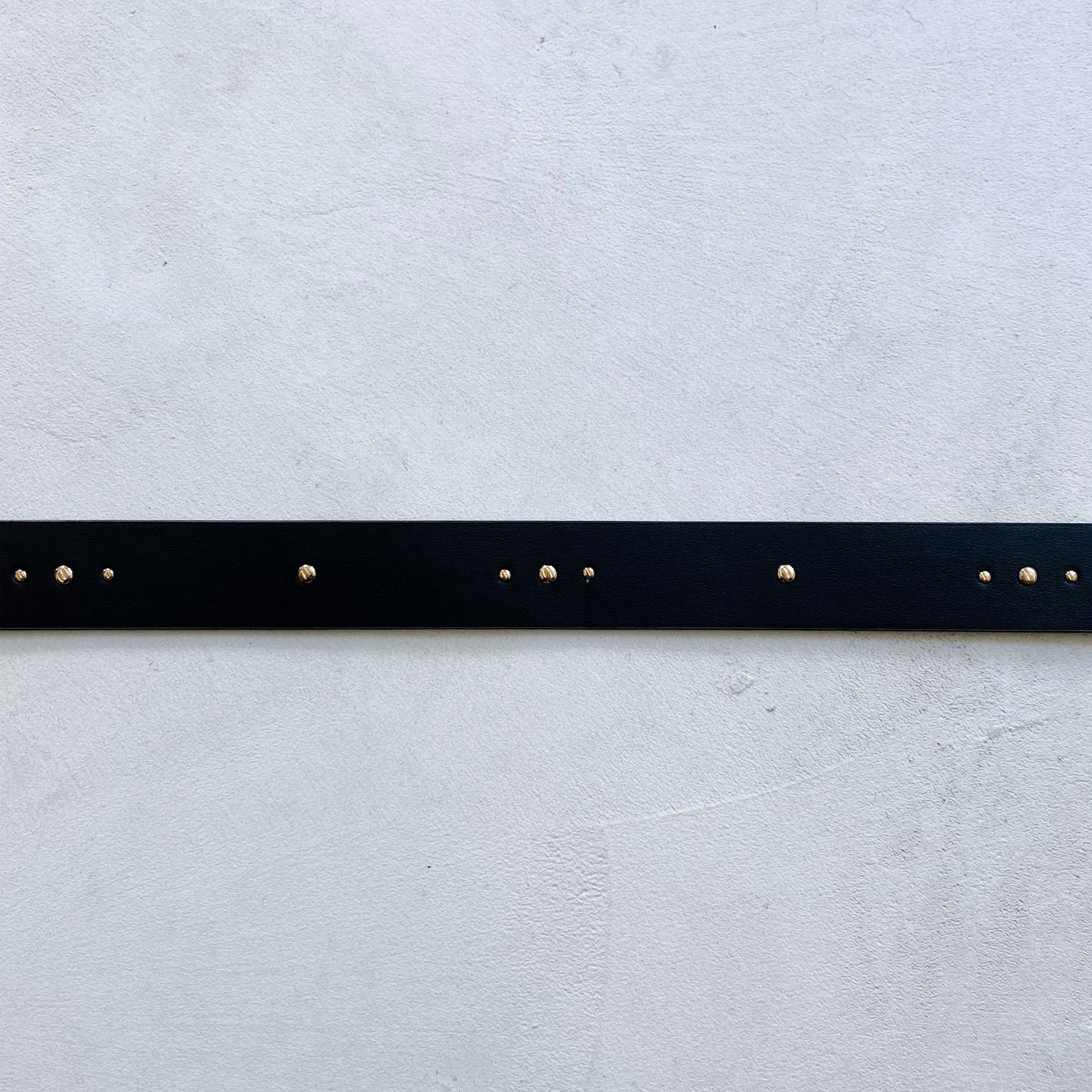 A Fabienne Chapot Studded Belt - Black with gold studs throughout.