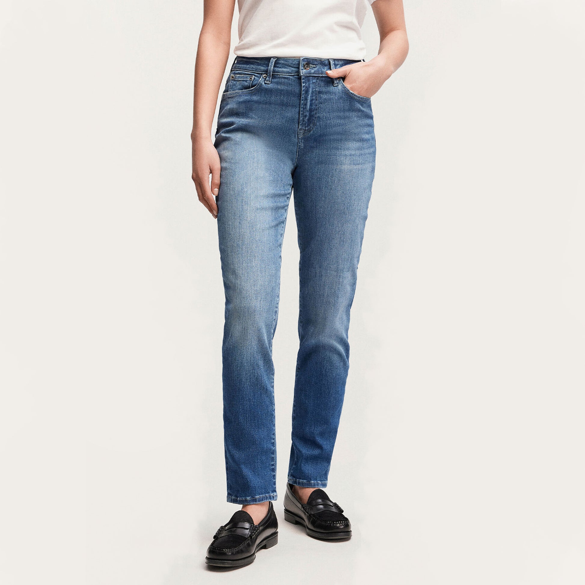 A woman wearing MARGOT High Slim - Light Worn Indigo jeans by Denham.