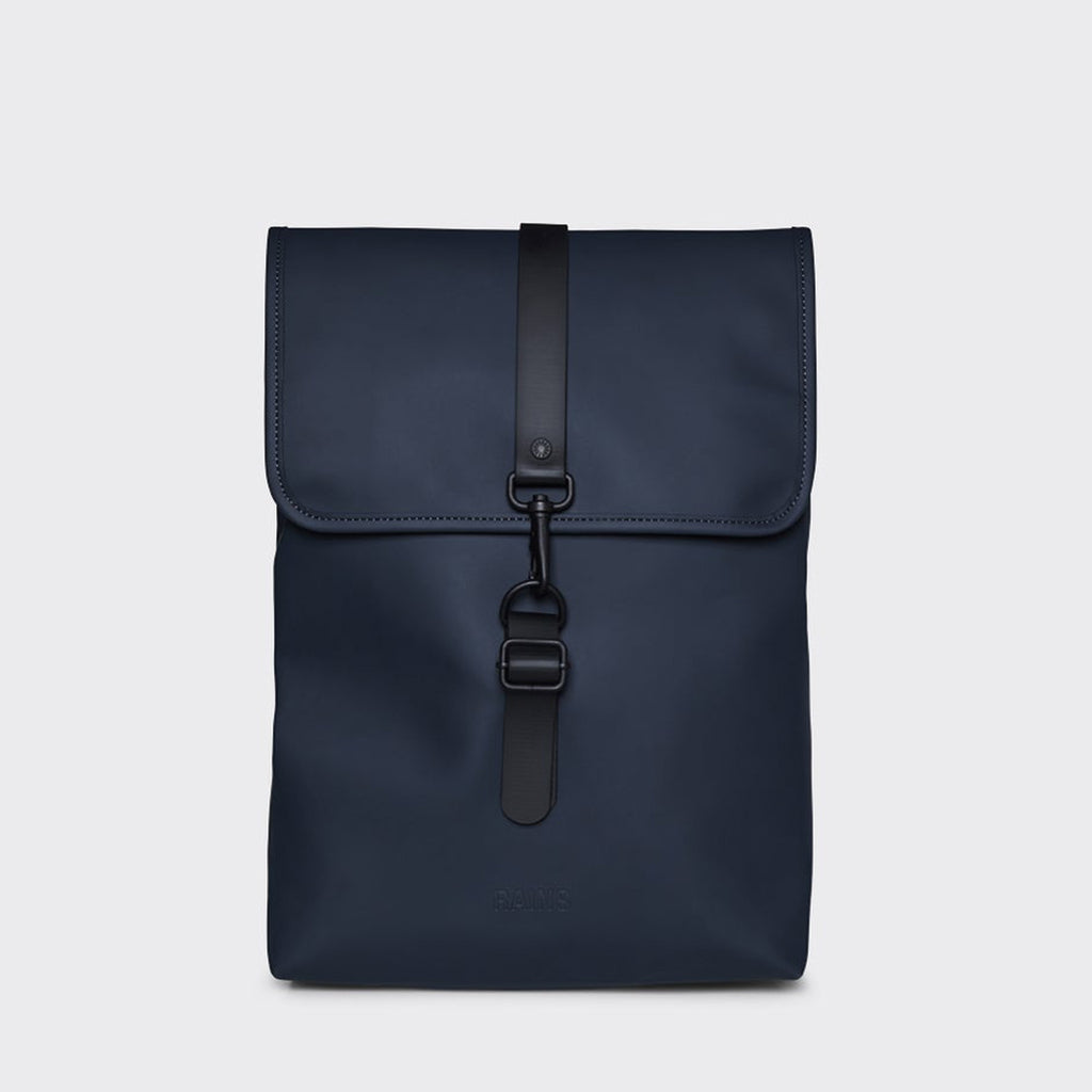 Matte navy rucksack with flap and black rubber central hook fastening
