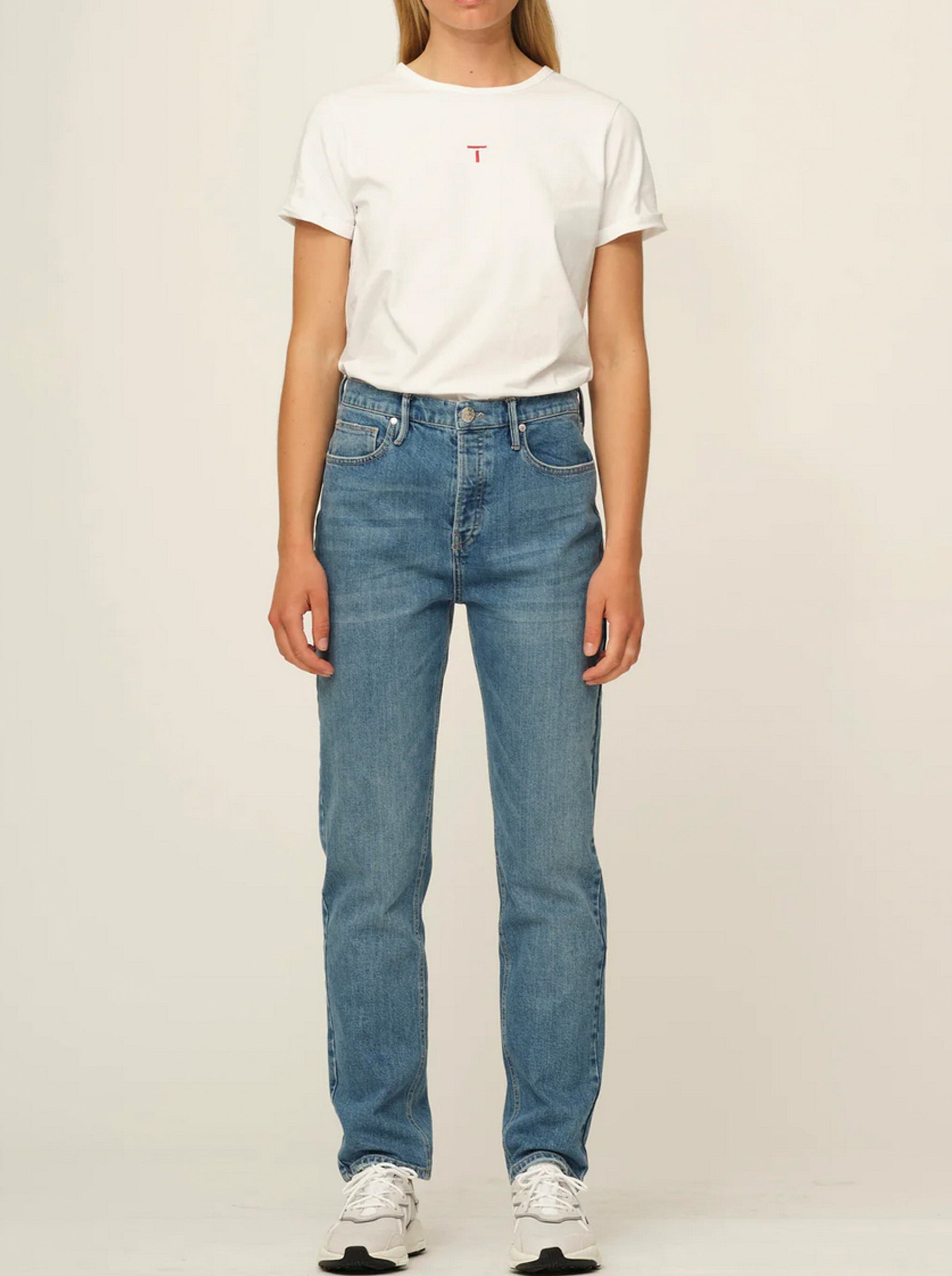 A woman wearing Teresa Jeans - Hong Kong high waist jeans and a white t-shirt.