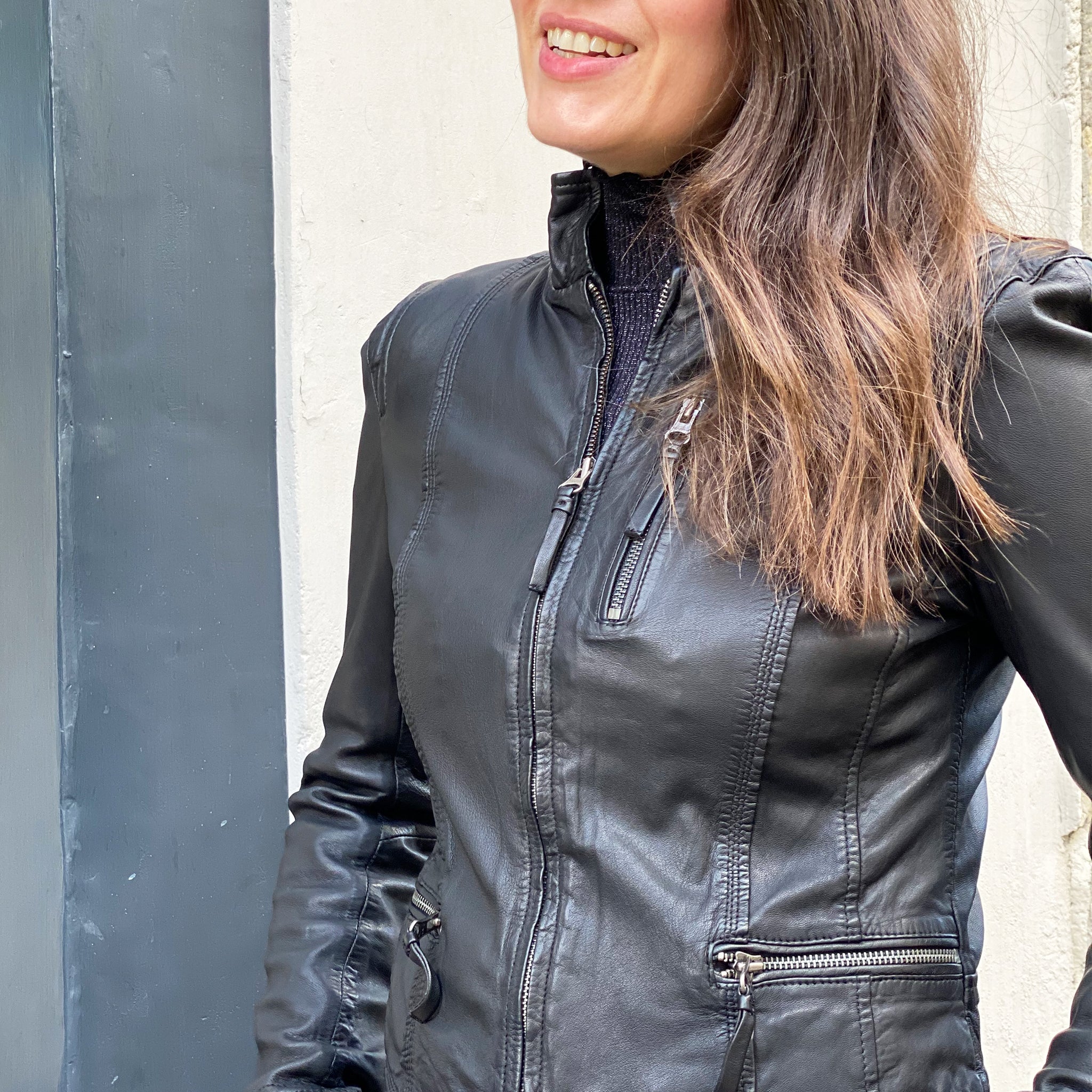 A woman sporting a fitted MDK Leather Rucy Jacket - Black.
