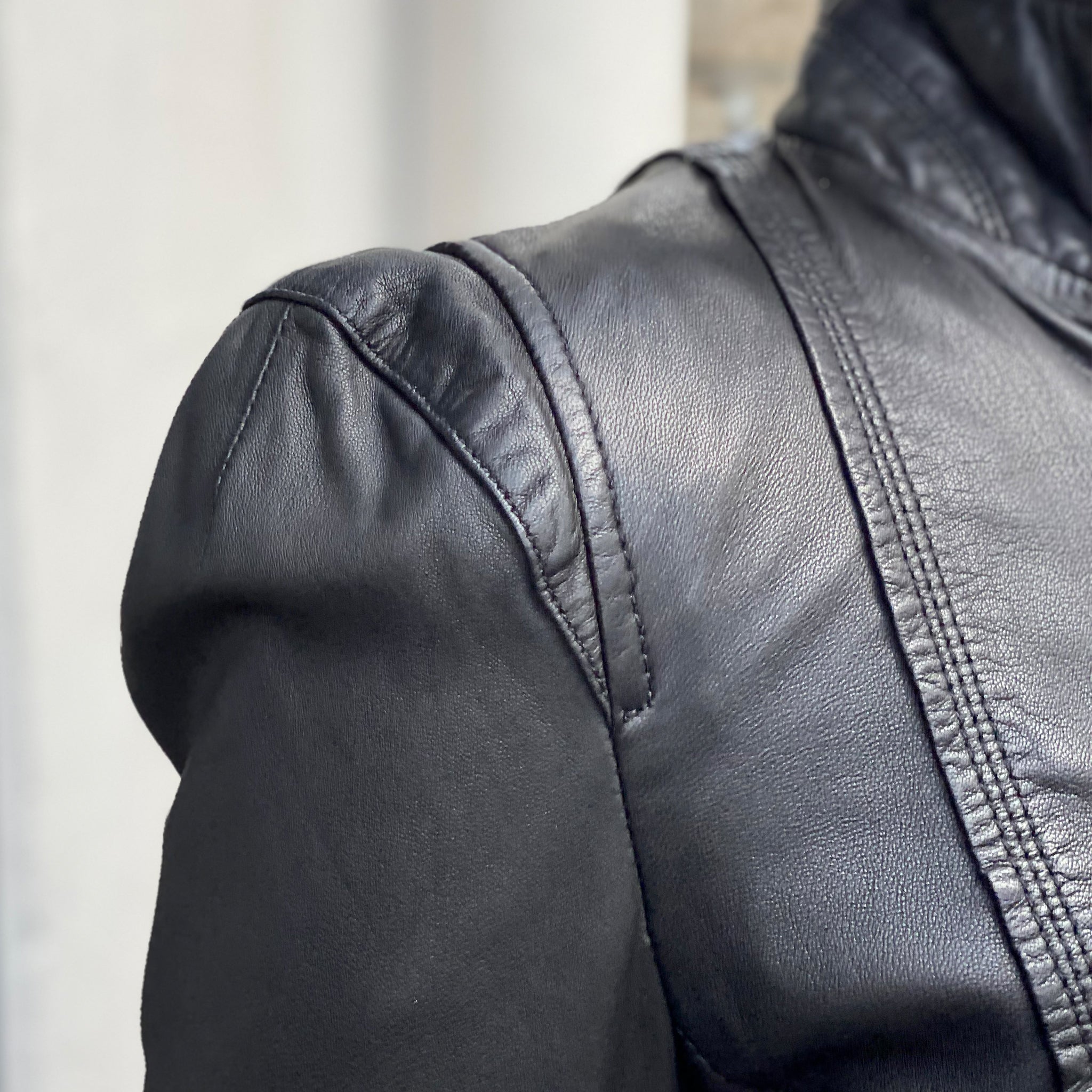 A close up of a woman wearing MDK's Leather Rucy Jacket - Black.