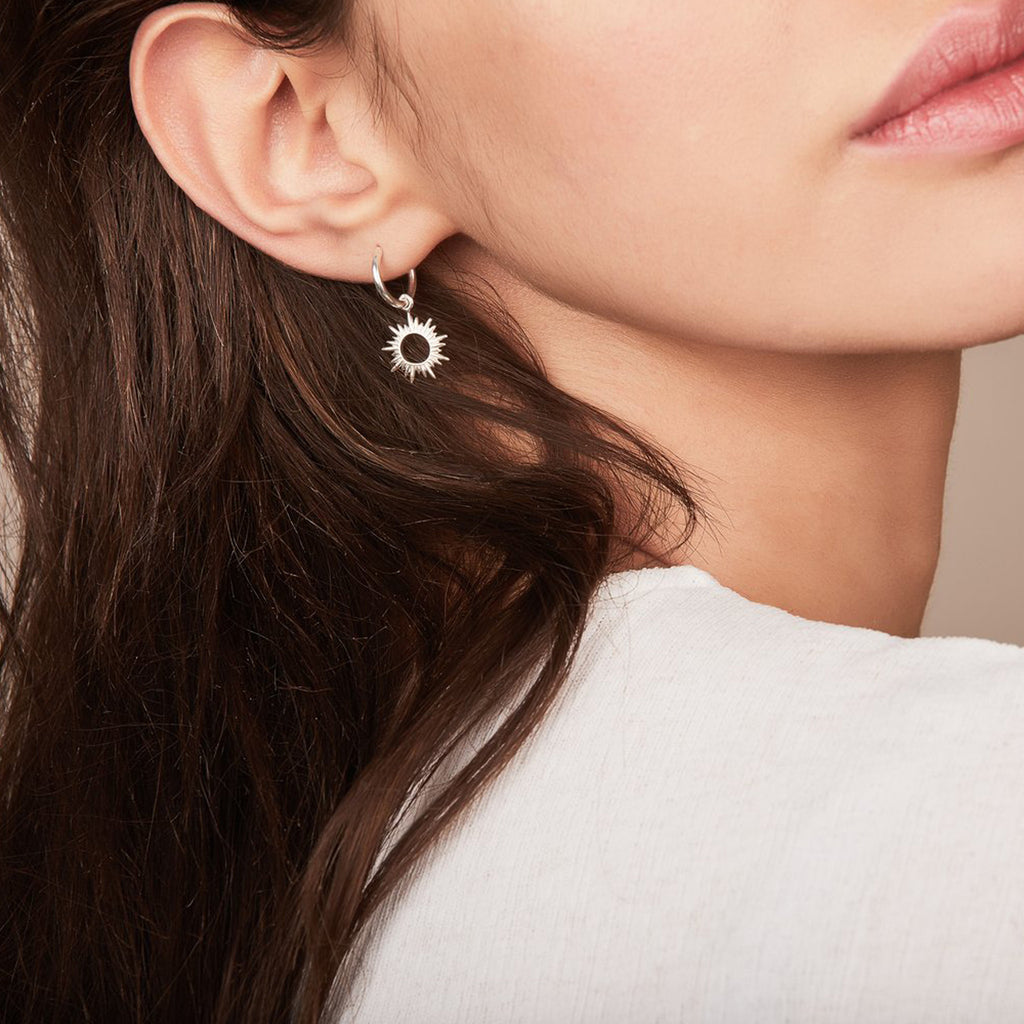 Woman wears the Eternal Sun earring by Rachel Jackson London 