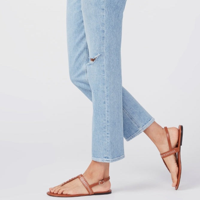 A woman wearing a pair of Paige Noella Straight Jeans - Montague Destructed and sandals.