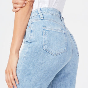 woman wears the Noella destruct jeans by Paige